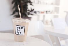 a cup with a straw in it sitting on a table