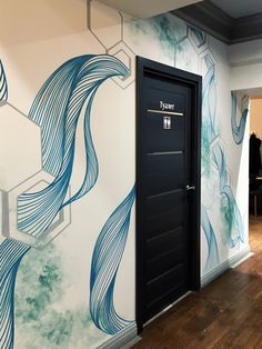 an open door is in front of a wall with blue swirls on the walls