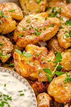 roasted potatoes with ranch dip and fresh herbs on the side, ready to be eaten