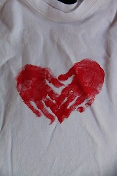 a white shirt with a red heart drawn on it