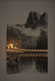 a lit up cabin on the shore of a lake at night with mountains in the background