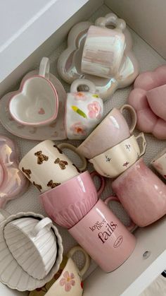 a drawer filled with lots of cups and saucers