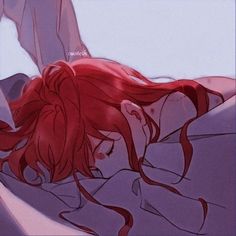 a red haired woman laying on top of a bed