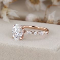 a close up of a diamond ring on a cushion