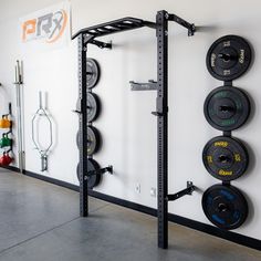 there is a wall mounted barbell rack in the gym