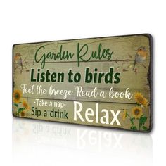 a wooden sign that reads garden rules listen to birds feed the breeze read a book take a map sip a drink