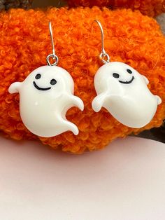 Something fun for the holiday season! Adorable pumpkins or ghost earrings made with resin and sterling silver ear hooks. You can even mix and match!! ✦Ghost measure 27mm (without earring hook) ✦Pumpkins measure (23mm without earring hook) ✦Earring hooks are .925 sterling silver ✦Earrings measure approximately 1 1/4" from top to bottom shown. ✦Charms are made with resin (cute and fun earrings) ✦Includes silicone backs so they stay in place **Photos are enlarged. Read measurements for details** Enjoy more of our bat collection below: https://www.etsy.com/shop/DaintyShack?ref=shop-header-name&listing_id=1581131315&from_page=listing&search_query=bats 🎁 Comes ready to gift - read packaging details below. PACKAGING: We try to be responsible about unnecessary packaging so if you'd like each piec Novelty White Drop Earrings, White Novelty Drop Earrings, Fun Nickel-free White Jewelry, Novelty White Sterling Silver Jewelry, White Sterling Silver Novelty Jewelry, Novelty White Dangle Earrings, White Hypoallergenic Fun Jewelry, Fun White Hypoallergenic Jewelry, Fun White Hypoallergenic Earrings