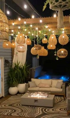 an outdoor living area with lights and furniture