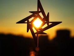 the sun is setting behind a star ornament