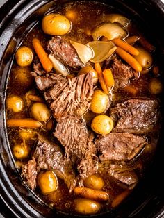 beef stew with carrots and potatoes in a crock pot, ready to be eaten