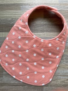 Each bib or burp cloth is made with a soft, 100% cotton flannel as a top and bottom layer with a third, absorbent layer in between. Bibs have a scooped neck line to fit your little one perfectly.  The outer edge of each bib or burp cloth is sewn down for added detail and durability. A plastic KAM snap is center on the back for an easy closure. (Snap color will coordinate with each bib)  Each item can be washed and dried. After drying, bibs can wrinkle up some and pull back out (they can also be Playful Cotton Bib, Machine Washable, Playful Cotton Bib Machine Washable, Cotton Playtime Bib For Babies, Cute Cotton Washable Bib, Cute Cotton Bib For Playtime, White Cotton Washable Bib, White Washable Cotton Bib, Pink Cotton Bib Machine Washable, Pink Cotton Machine Washable Bib