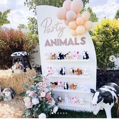 there is a sign that says party animals on it with balloons and flowers in the background