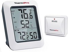 an alarm clock and thermometer on a white background