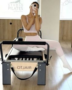 a woman taking a selfie while sitting in a chair