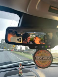 two people are seen in the rear view mirror of a car as they look at each other