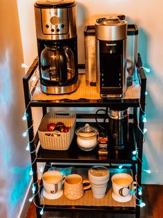 a shelf with coffee mugs, toaster and other items on it in front of a wall