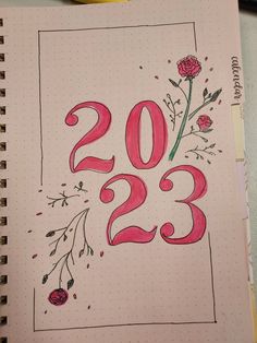 a notebook with the number twenty two in it and flowers drawn on top of it