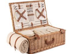 a wicker picnic basket with utensils in it