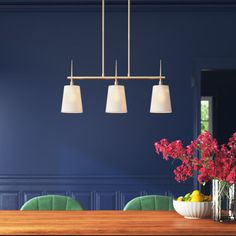 a dining room with blue walls, green chairs and a wooden table in the center