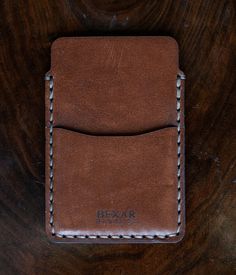 DESCRIPTION The Simple Card Wallet is one of our most simple wallets. It features two pockets, one main pocket for card storage, and one quick access pocket. The Simple Card Wallet is saddle stitched by hand, joining each leather piece together with a durable poly cord thread. The saddle stitch technique has been favored for centuries by expert leather workers, and has a distinct durability advantage when compared to the lock stitch technique produced by machine stitching. If you like to keep th Hand-stitched Leather Card Holder For Everyday Use, Simple Wallet, Saddle Stitch, Card Storage, Leather Pieces, Simple Cards, Card Wallet, Saddle, Wallets