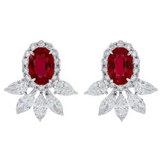 Elegant and exquisitely detailed 18 Karat White Gold Earrings, center set with 1.32Cts .Oval Shape vibrant Red Mozambique Ruby and micro pave set Diamonds, weighing approx. 1.14Cts Beautifully Hand crafted in 18 Karat White Gold. Stone Detail: Ruby Mozambique: 6x4MM Stone Weight: Ruby Mozambique: 1.32Cts Diamond: GH/SI Total Diamond Weight: 1.14Cts Oval Diamond Bridal Earrings With Brilliant Cut, Luxury Oval Bridal Earrings With Prong Setting, Oval Diamond Cluster Earrings For Formal Events, Oval Earrings With Pave Setting For Wedding, Oval Wedding Earrings With Pave Setting, Oval Bridal Earrings Fine Jewelry, Oval Fine Jewelry Bridal Earrings, Oval Diamond Bridal Earrings With Diamond Accents, Oval Diamond Bridal Earrings With Accents