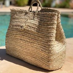 "Unleash your boho side with this beautiful handmade beach basket. Berber Artisanal Handbag Basket "Targua" The "Targua" basket is a unique piece, handmade by talented Berber women artisans in Morocco. Each bag is unique, reflecting the rich cultural heritage and creativity of these artisans. Material: Eco-friendly and durable The "Targua" bag is made from high quality natural materials called doum (a small palm tree that grows in North Africa. Berber women use these palm leaves called doum. Des Handwoven Natural Color Beach Bag, Handwoven Natural Fiber Beach Bag, Natural Handwoven Natural Fiber Beach Bag, Natural Weaved Straw Bag For Travel, Artisan Beige Straw Bag For Market, Handwoven Natural Straw Bag, Natural Handwoven Basket Beach Bag, Natural Basket-shaped Handwoven Beach Bag, Woven Natural Fiber Straw Bag For Travel