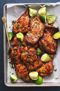 grilled chicken with limes and cucumbers on a tray