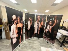 three black and white pictures on display in an office setting with one woman talking on the phone