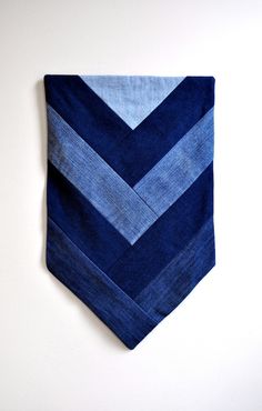 a blue and white striped tie hanging on the wall