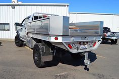 a silver truck parked in front of a building