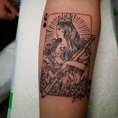 a woman with long hair and a crown on her head is depicted in this tattoo