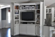 a white entertainment center with built in bookshelves