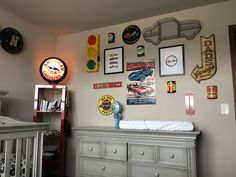 a baby's room with lots of pictures on the wall