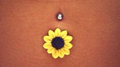 a yellow and black flower is on the side of a woman's stomach,