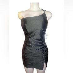 a mannequin is wearing a black dress with one shoulder draped over it and an asymmetrically shaped skirt