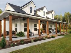 a white house with porches and chairs on the front