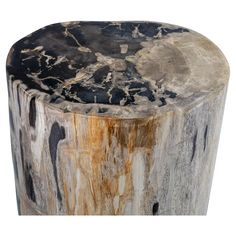 a round wooden table with black and white paint on the top, sitting in front of a white background