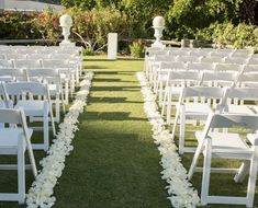 rows of white chairs lined up on the grass