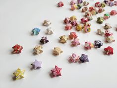 many different colored origami stars on a white surface