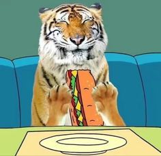 a tiger holding a large sandwich in front of it's face while sitting on a couch