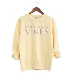 The perfect cozy sweatshirt for Vikings Football games! Product Details: * Relaxed fit, medium-heavy fabric * 80% ring-spun cotton, 20% polyester * Color: Butter * Unisex Fit; Please refer to the sizing chart in the listing photos to find your perfect fit! Care Details: * To maintain the quality of your sweatshirt, wash inside out on a delicate cycle and in cold water * Hang dry or lay flat to dry Shipping Details: * This product is made especially for you as soon as you place an order, which is why it takes a bit longer to deliver it to you.  * Please allow 1-2 weeks for processing, thank you! Comfortable Cozy Fit Sports Sweatshirt, Comfortable Fleece Tops, Comfy Cotton Sports Tops, Sporty Cotton Tops With Cozy Fit, Relaxed Fit Fleece Tops For Sports, Cozy Fit Sweatshirt For Sports, Sporty Soft-washed Cotton Sweatshirt, Yellow Relaxed Fit Sweatshirt For Loungewear, Comfy Relaxed Fit Tops For Sports