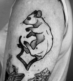 a man with a rat tattoo on his arm