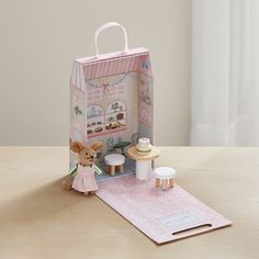 a small doll house with a teddy bear inside