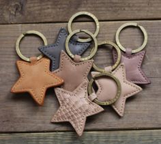 leather keychains with star and moon shapes on them