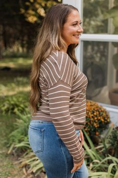 Fit & Details: True to size with great stretch. Lightweight knit material with ribbed hems V-neckline Center seam detail Drop shoulder sleeves Measurements: X-Small: Bust 36" Length 22" Small: Bust 38“ Length 22.5“ Medium: Bust 40“ Length 23“ Large: Bust 42“ Length 23.5“ X-Large: Bust 44" Length 24" Fabric & Material Care: Machine wash cold on delicate. Lay flat to dry. 55% Viscose, 45% Nylon. *Imported* Model Info: Britta is modeling a small. Leah is modeling a large. Leah R. is modeling a medium. Casual Brown Knit V-neck Sweater, Casual Brown Sweater With Ribbed Neckline, Taupe V-neck Top For Fall, Brown Long Sleeve V-neck Sweater For Spring, Casual Brown Top With Ribbed Neckline, Casual Knit Taupe Top, Casual Taupe Knit Tops, Brown Knit Top With Ribbed Neckline, Brown Knit Tops With Ribbed Neckline