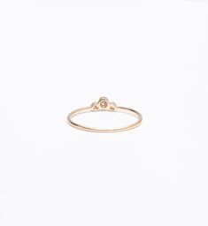 A slightly larger center and offset, delicate sides impart this delicate stacking ring with just the right amount of size and an unexpected silhouette. Though you can easily wear it on its own, you'll find a million ways to stack it thanks to the tiny space its curved design makes. Nestle it alongside other delicate rings for a multitude of sparkle or let it snuggle alongside a chunkier signet ring for maximum impact. Made in the U.S.A. Center setting measures 0.25" wide. 14 karat gold with thre Delicate Stacking Rings, Band Necklace, Vintage Engagement Rings Unique, Diamond Cluster Engagement Ring, Tiny Space, Engagement Ring White Gold, Cluster Engagement Ring, Bezel Ring, Wedding Bridal Jewellery