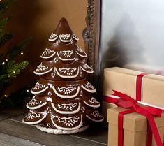 a chocolate christmas tree sitting next to a gift box