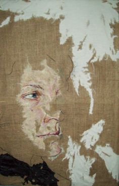 a painting of a man's face on a piece of burlied fabric