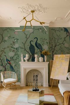 the living room is decorated with peacocks and birds on green wallpaper, along with a fireplace