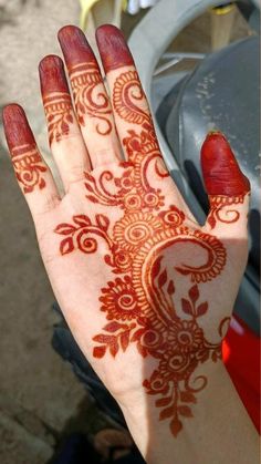 the hand is decorated with henna on it